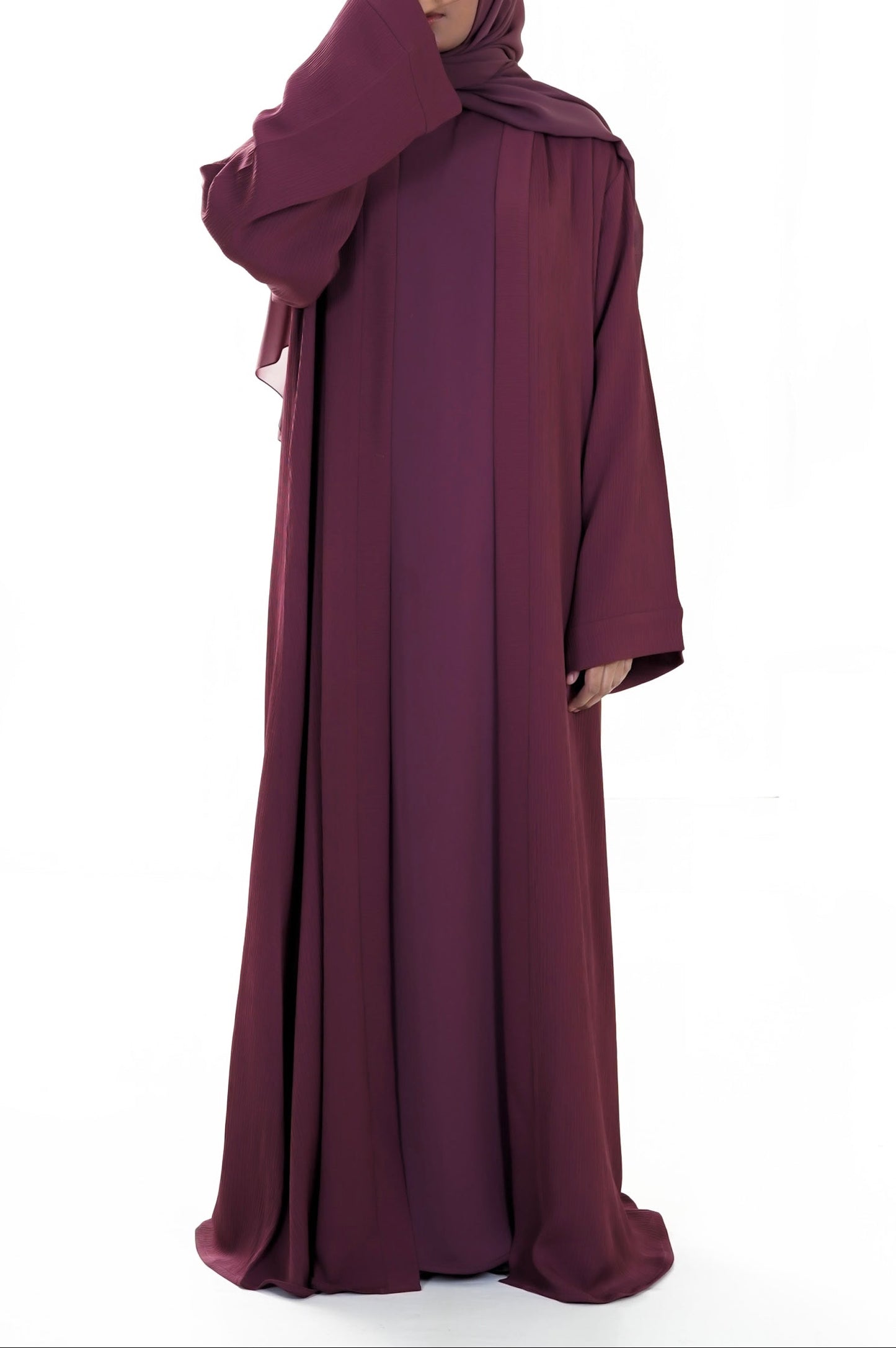 Maroon abaya worn by a model on a white background