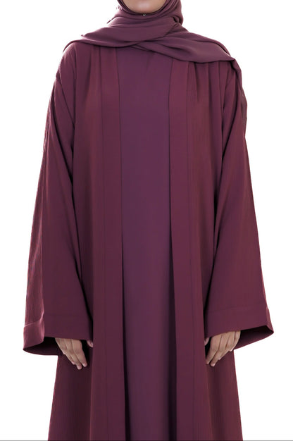 Maroon abaya worn by a model on a white background
