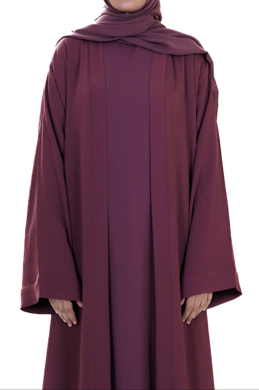 Maroon abaya worn by a model on a white background
